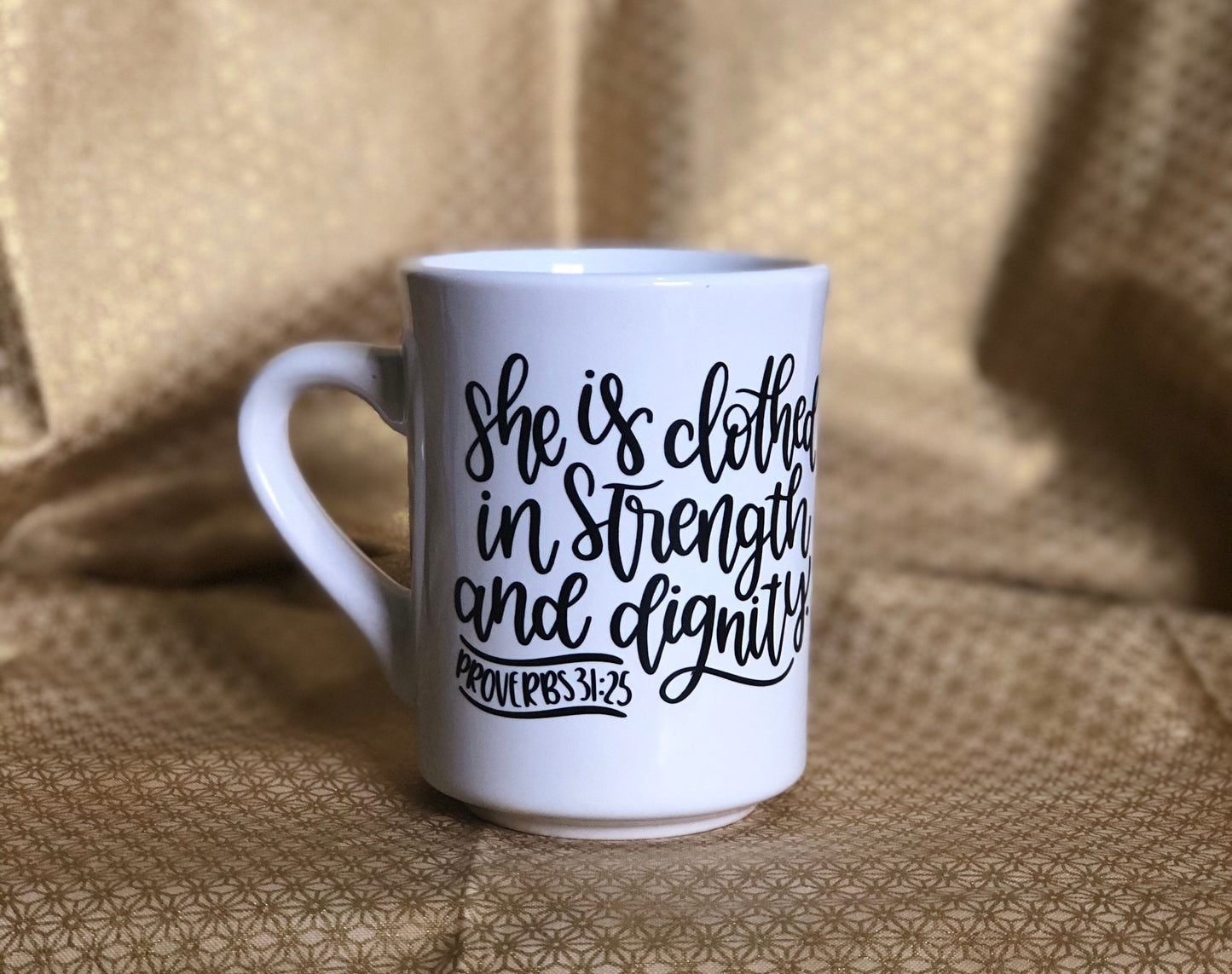 She is clothed....Enjoy your coffee in this 11 ounce ceramic coffee cup!