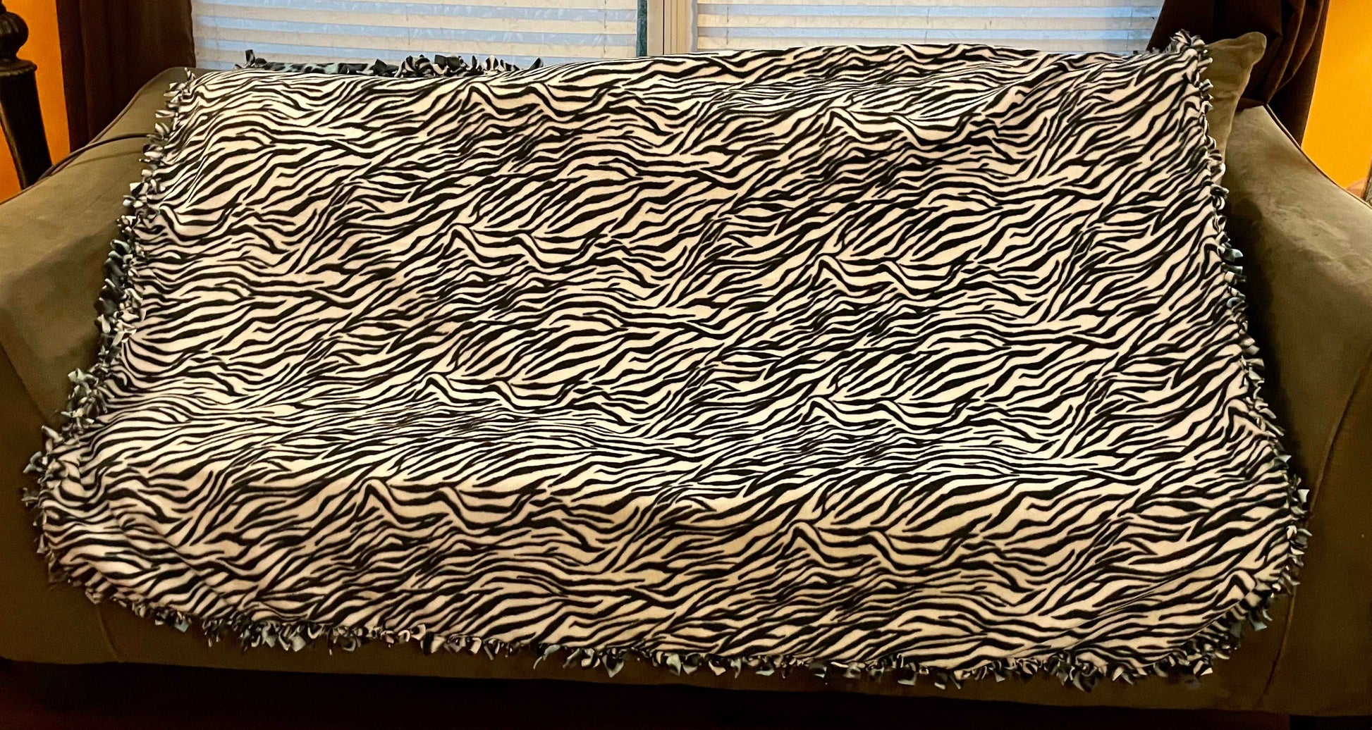 Cuddle up and stay warm with one of my medium size fleece tie knot blankets