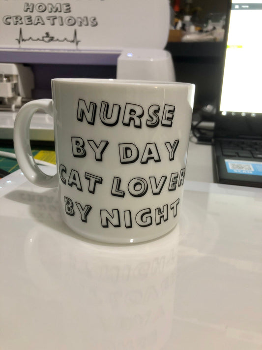 Nurse by day cat lover by night! Enjoy your coffee in this 14 ounce ceramic coffee cup!